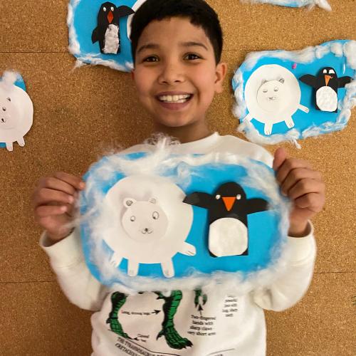 Bub zeigt selbst gemachtes Bild mit Eisbär und Pinguin